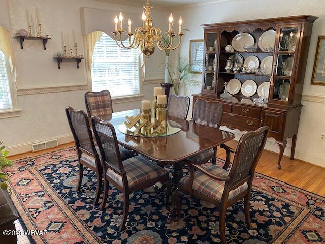 1550 Campbell St, Williamsport, PA 17701 - dining space featuring visible vents, plenty of natural light, wood finished floors, and a chandelier