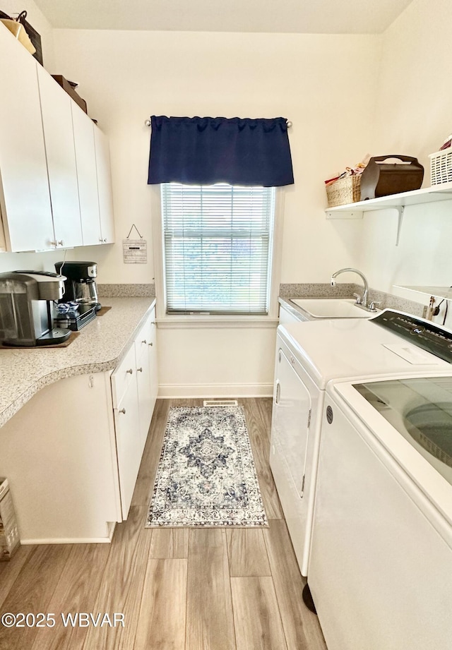 2035 Woodland Rd, Montoursville, PA 17754 - laundry room featuring light wood-style floors, separate washer and dryer, and baseboards