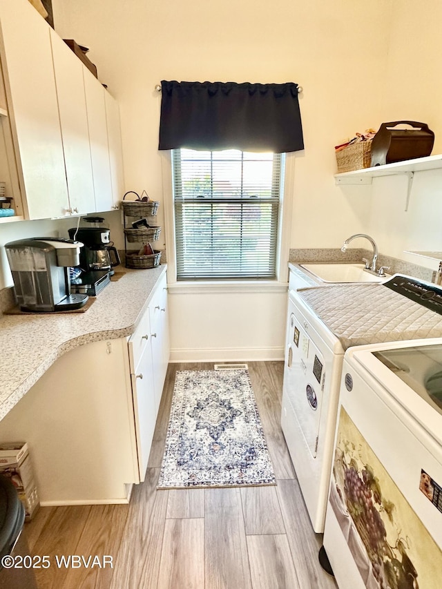 2035 Woodland Rd, Montoursville, PA 17754 - clothes washing area featuring a sink, light wood-style floors, washing machine and clothes dryer, and baseboards