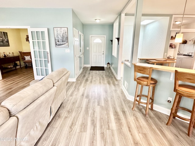 2035 Woodland Rd, Montoursville, PA 17754 - foyer with light wood finished floors, separate washer and dryer, and baseboards