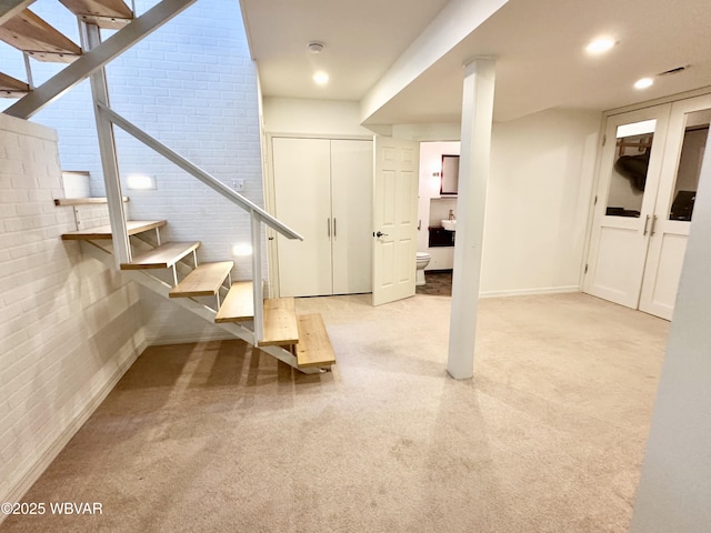 2035 Woodland Rd, Montoursville, PA 17754 - basement with brick wall, carpet floors, stairs, baseboards, and recessed lighting