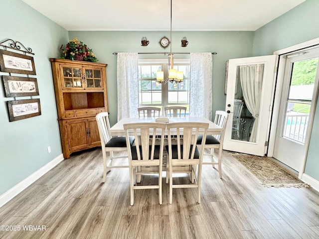2035 Woodland Rd, Montoursville, PA 17754 - dining room featuring a chandelier, light wood-style flooring, and baseboards