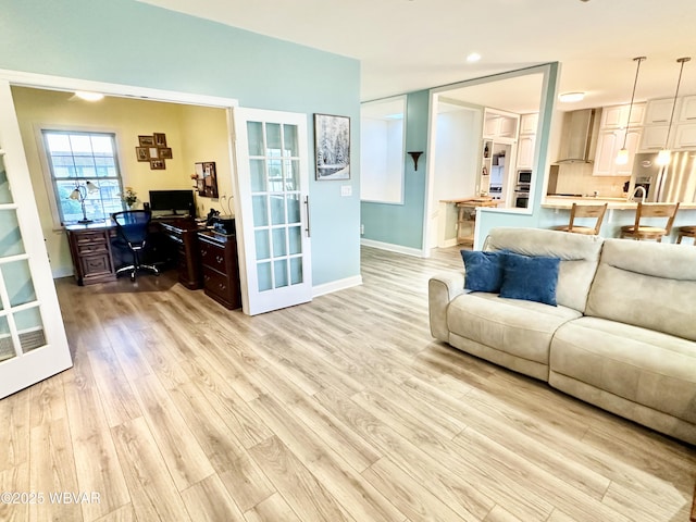 2035 Woodland Rd, Montoursville, PA 17754 - living area with a desk, light wood-style flooring, baseboards, recessed lighting, and french doors