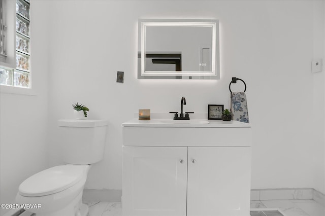 bathroom featuring toilet and vanity