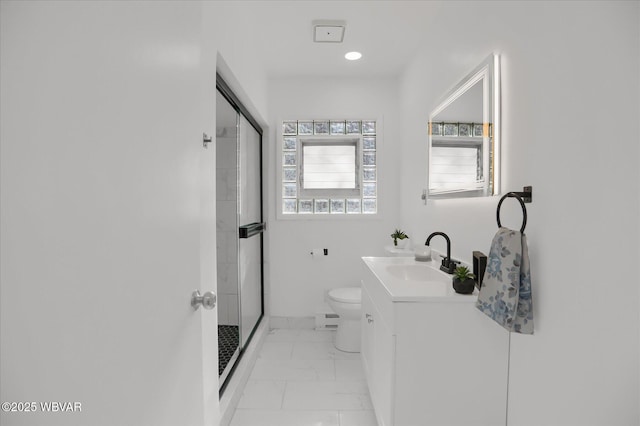 bathroom featuring vanity, toilet, baseboard heating, and a shower with door