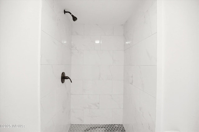 bathroom with a tile shower