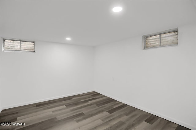 basement with dark hardwood / wood-style floors