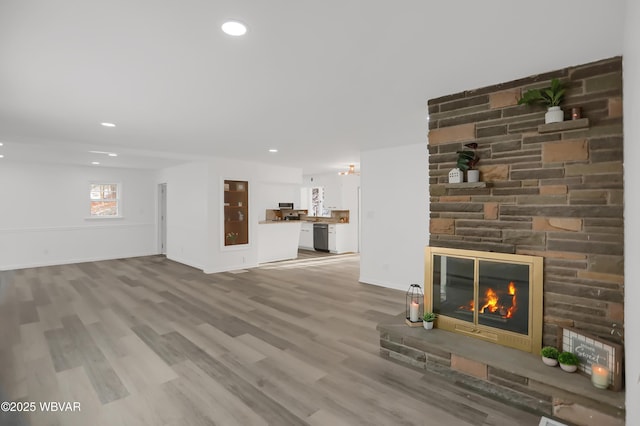 unfurnished living room featuring a fireplace and hardwood / wood-style flooring