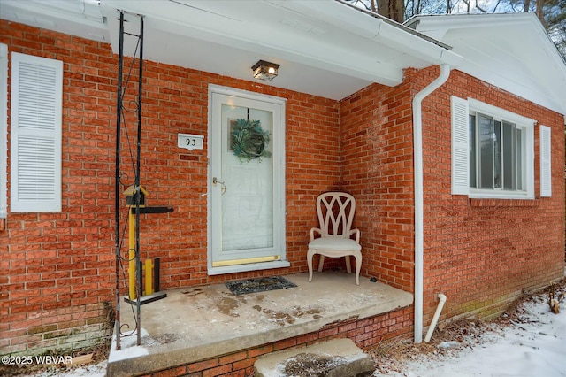 view of snow covered property entrance