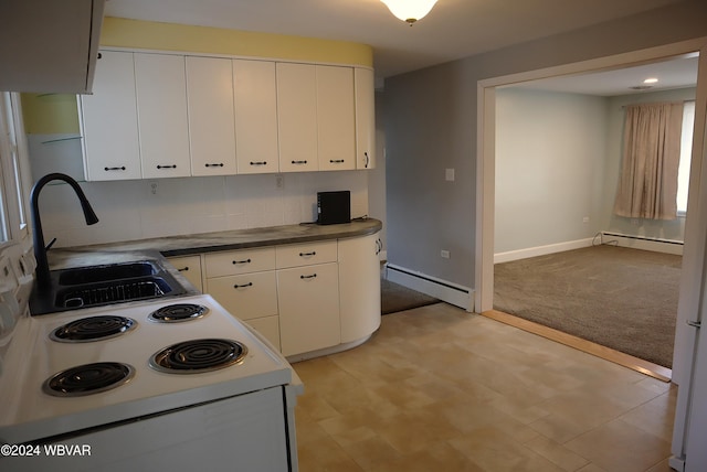 kitchen featuring white cabinetry, baseboard heating, and sink