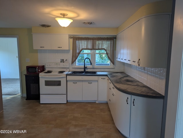 kitchen with white electric range, backsplash, white cabinetry, and sink