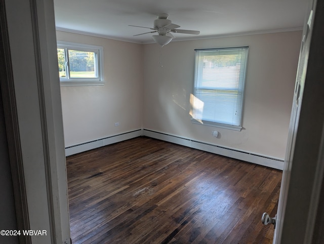 spare room featuring ceiling fan, crown molding, baseboard heating, and dark wood-type flooring