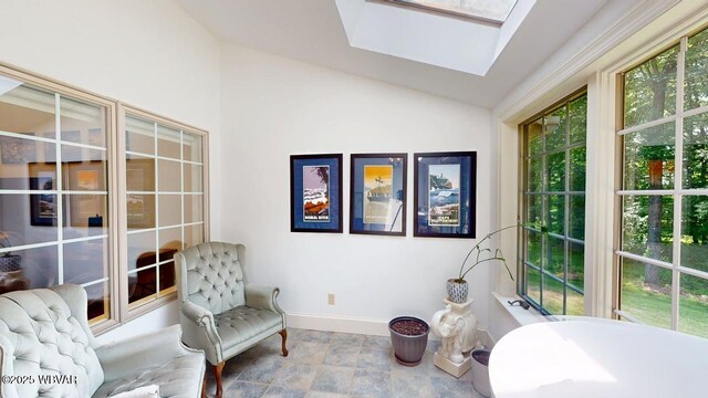 2180 Stopper Dr, Montoursville, PA 17754 - living area with vaulted ceiling, baseboards, a skylight, and stone finish flooring