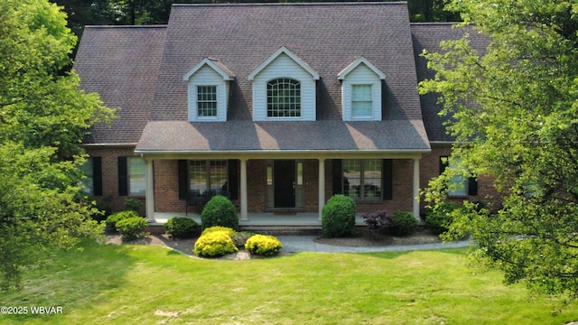 2180 Stopper Dr, Montoursville, PA 17754 - cape cod-style house with covered porch, a front yard, and brick siding
