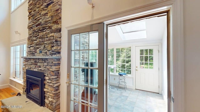 2180 Stopper Dr, Montoursville, PA 17754 - entryway featuring a skylight, a fireplace, healthy amount of natural light, and baseboards