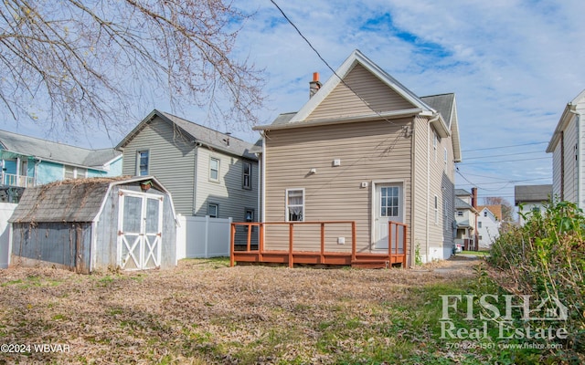 back of house featuring a storage shed and a wooden deck