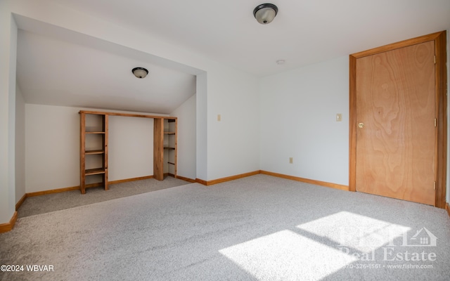 unfurnished bedroom with light carpet and a closet