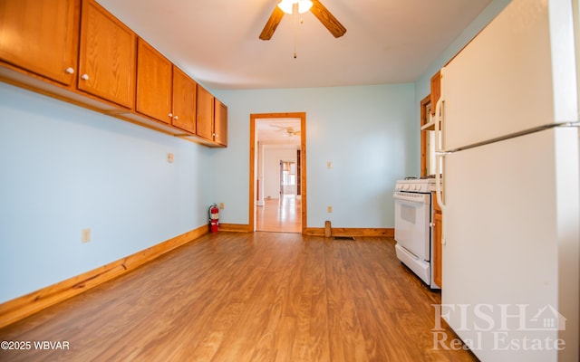 435 Grant St, Williamsport, PA 17701 - kitchen featuring white appliances, brown cabinetry, a ceiling fan, light wood finished floors, and baseboards