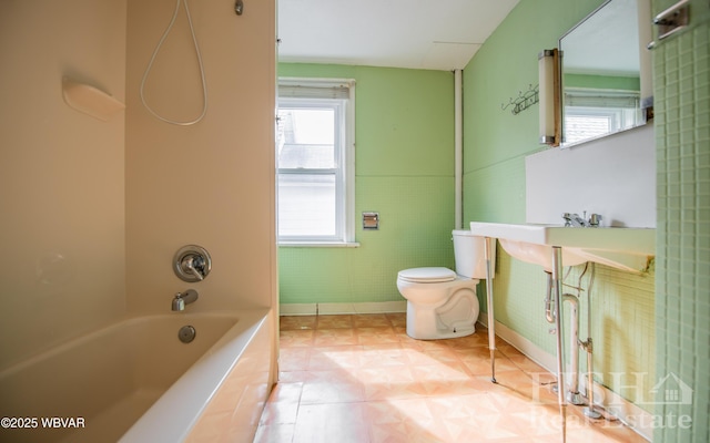 435 Grant St, Williamsport, PA 17701 - bathroom with toilet, baseboards, tile patterned flooring, and washtub / shower combination