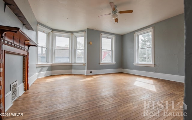 435 Grant St, Williamsport, PA 17701 - unfurnished living room featuring light wood-type flooring, baseboards, and a ceiling fan
