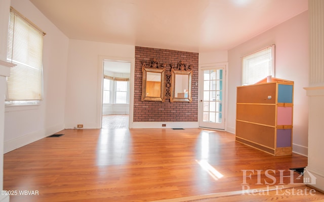 435 Grant St, Williamsport, PA 17701 - unfurnished living room featuring a wealth of natural light, visible vents, and wood finished floors