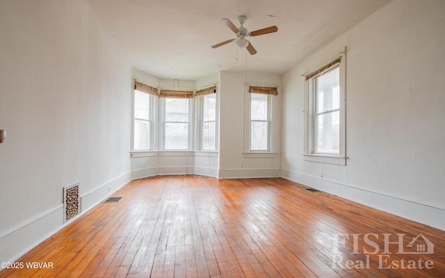 435 Grant St, Williamsport, PA 17701 - unfurnished room featuring ceiling fan, wood-type flooring, and visible vents
