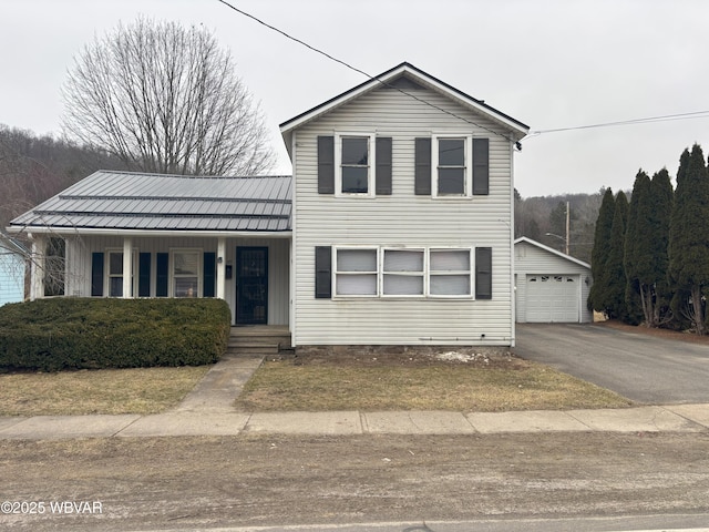 145 Gulick St, Blossburg, PA 16912 - traditional-style home with aphalt driveway, an outbuilding, covered porch, and metal roof