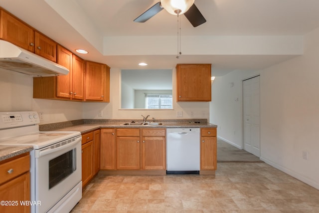 kitchen with sink, white appliances, a raised ceiling, and ceiling fan