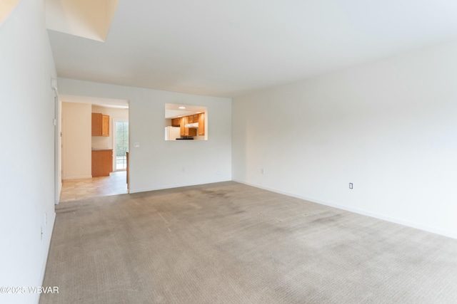 unfurnished room featuring light carpet