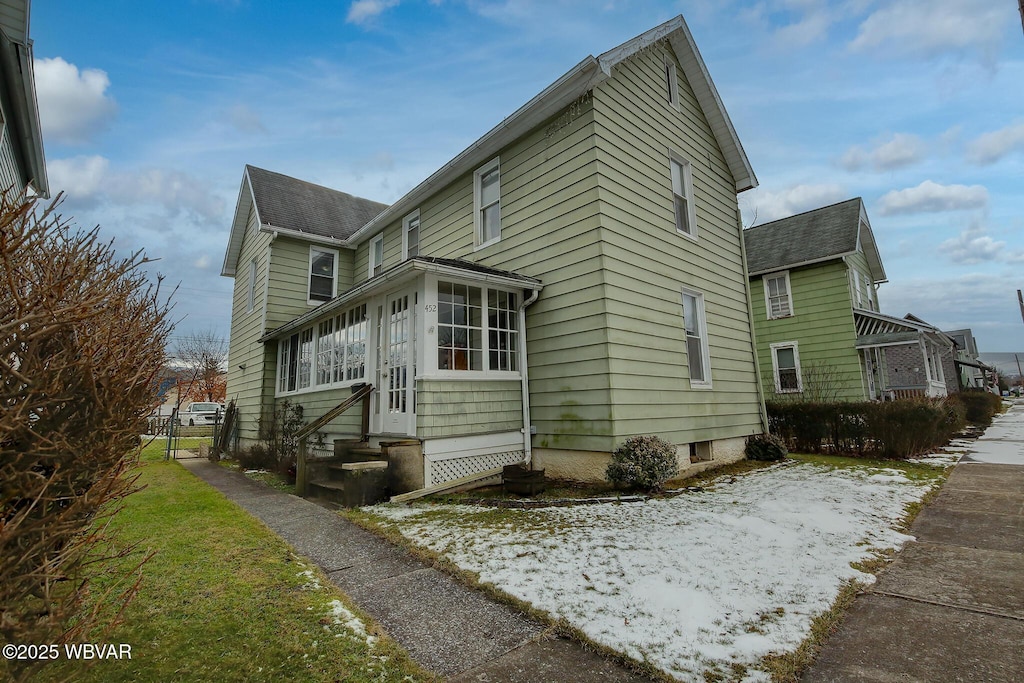 view of home's exterior featuring a sunroom