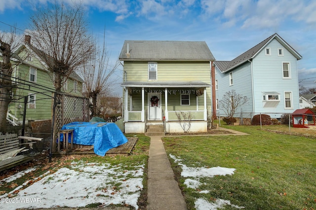 view of front of house featuring covered porch and a front yard