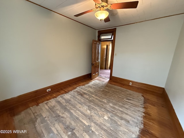 empty room featuring hardwood / wood-style flooring, ceiling fan, and ornamental molding