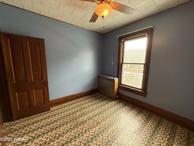 empty room with ceiling fan and radiator