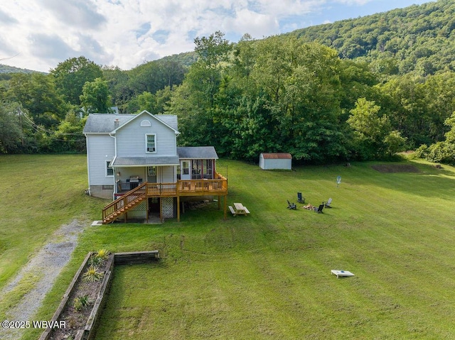 229 River Rd, Renovo, PA 17764 - back of house with driveway, an outdoor structure, a deck, and a yard