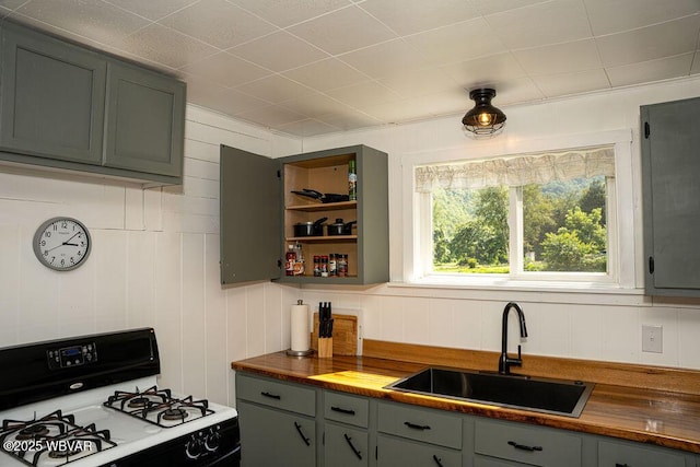 229 River Rd, Renovo, PA 17764 - kitchen featuring butcher block counters, gas stove, a sink, open shelves, and gray cabinetry