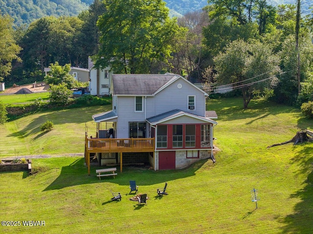 229 River Rd, Renovo, PA 17764 - back of house featuring a lawn, a sunroom, and a wooden deck