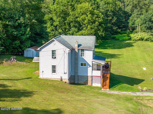 229 River Rd, Renovo, PA 17764 - view of side of home with an outdoor structure, stairway, roof with shingles, a shed, and a yard