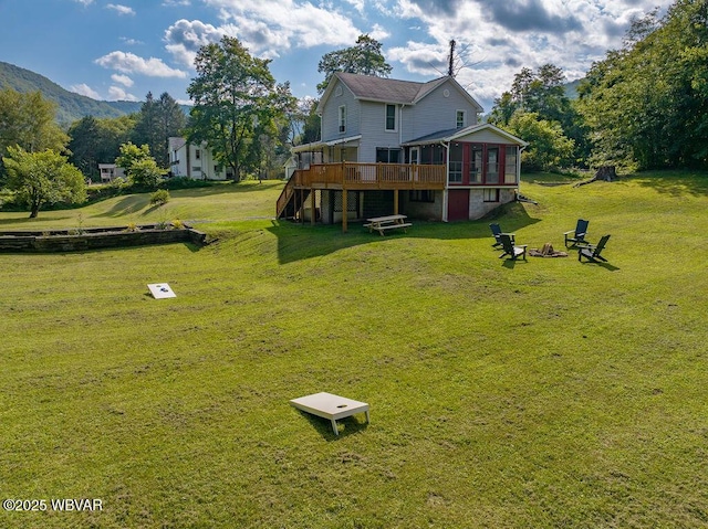 229 River Rd, Renovo, PA 17764 - view of yard featuring a sunroom, a fire pit, stairs, and a deck
