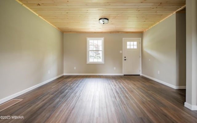 spare room featuring crown molding, baseboards, and wooden ceiling
