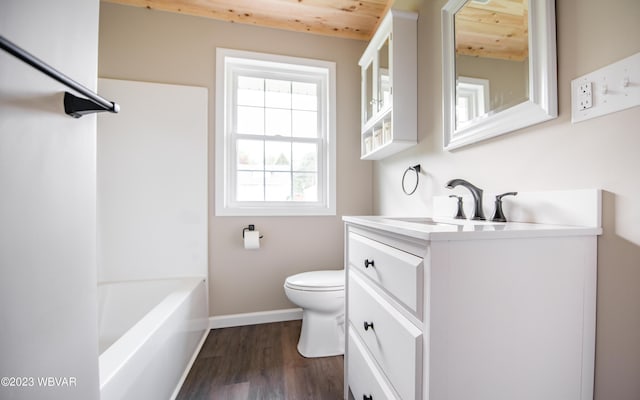 full bath with wood finished floors, toilet, vanity, and baseboards