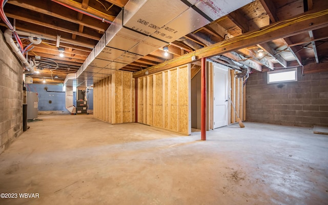 below grade area featuring heating unit and water heater