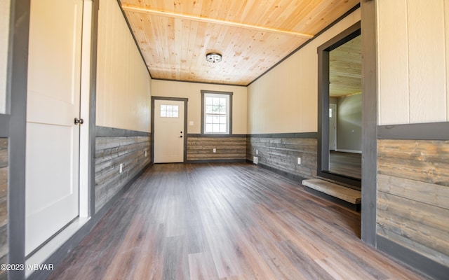 additional living space with wood ceiling, wooden walls, and dark wood-style floors