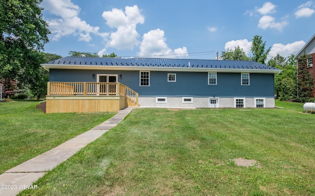 rear view of property featuring a yard and metal roof