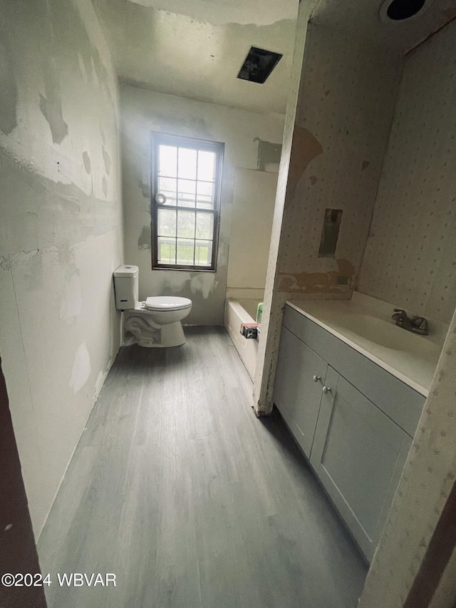 full bathroom with hardwood / wood-style flooring, vanity, toilet, and bathing tub / shower combination