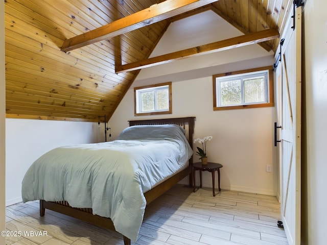 bedroom with vaulted ceiling with beams, wood ceiling, a barn door, and light wood-type flooring