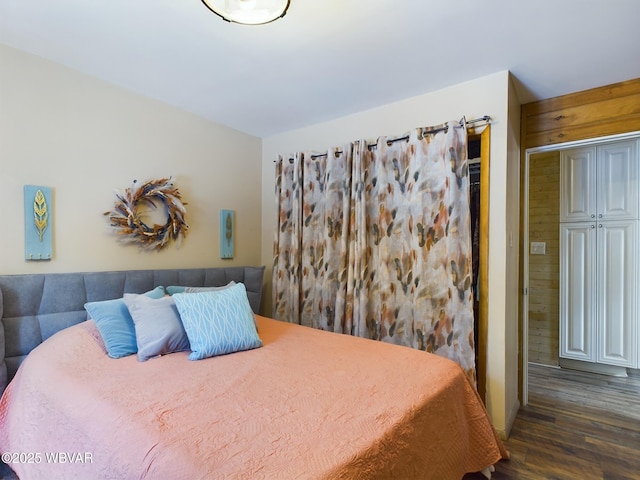 bedroom featuring dark hardwood / wood-style floors and a closet