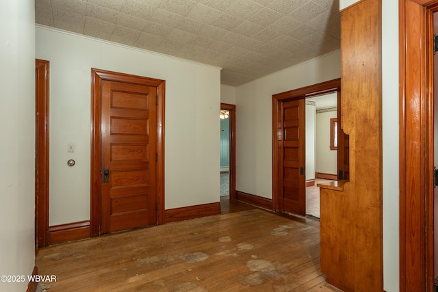 interior space with hardwood / wood-style flooring and crown molding