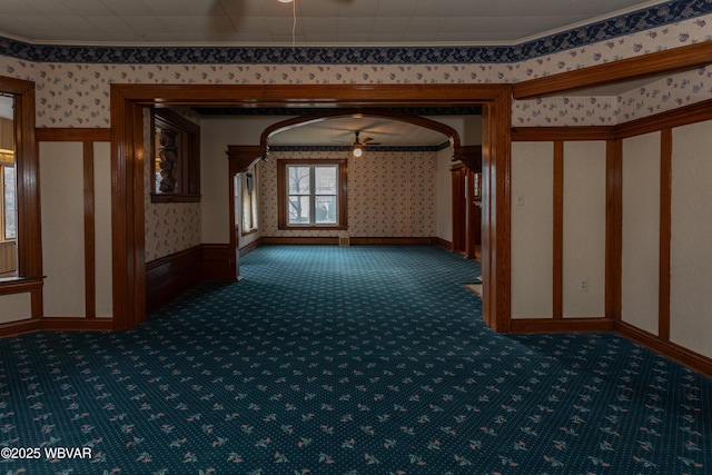 hall featuring crown molding and dark colored carpet