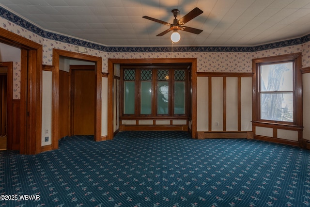 misc room featuring ceiling fan and dark colored carpet