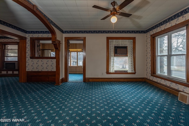 carpeted empty room with ornamental molding and ceiling fan